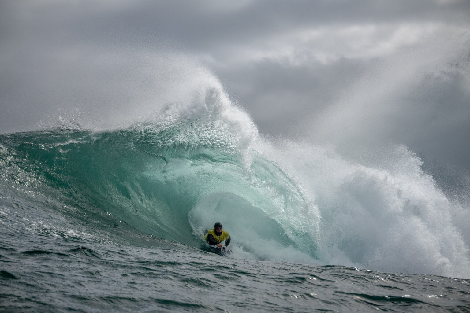 Bodyboarder riding monster wave.