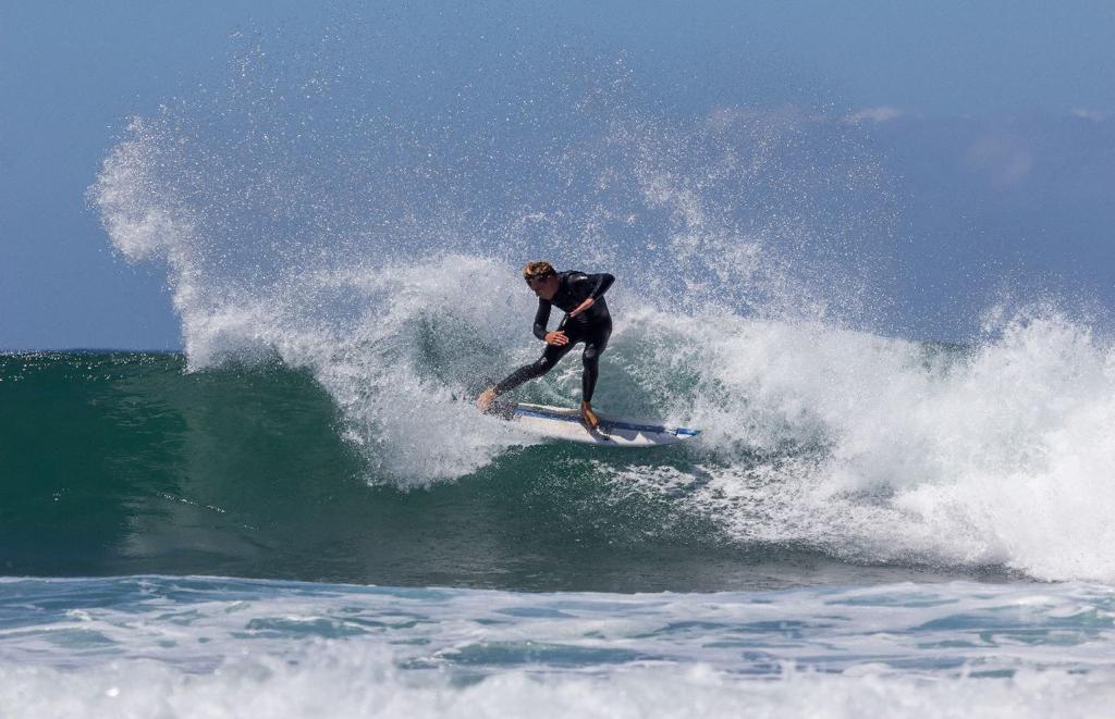 surfer snaps a forehand roundhouse cutback.