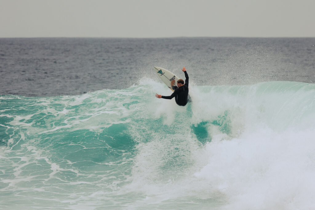 surfer goes vertical on a massive wave